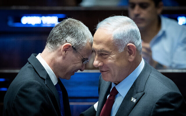 Likud chief Benjamin Netanyahu (R) speaks with MK Yariv Levin during Levin's election as Knesset speaker, December 13, 2022. (Yonatan Sindel/Flash90)