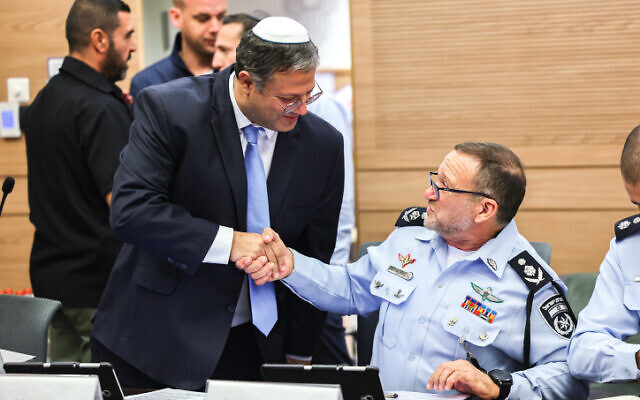 MK Itamar Ben Gvir and Chief of Police Kobi Shabtai shake hands at an Arrangements Committee meeting in the Knesset on December 14, 2022. (Yonatan Sindel/Flash90)