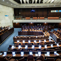 A nearly empty plenum hall during a Knesset session on December 18, 2022. (Yonatan Sindel/Flash90)