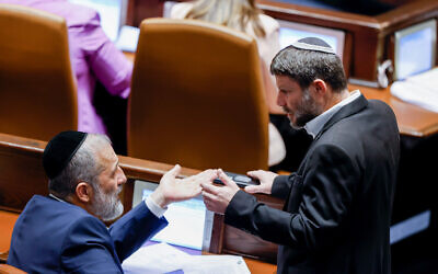 MKs Aryeh Deri and Bezalel Smotrich seen during a plenum session at the Knesset, on December 19, 2022. (Olivier Fitoussi/Flash90)