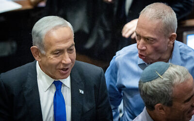 Likud leader MK Benjamin Netanyahu speaks with his expected defense minister Yoav Gallant in the Knesset on December 20, 2022. (Yonatan Sindel/Flash90)