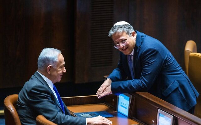 Likud leader MK Benjamin Netanyahu with Otzma Yehudit party head Itamar Ben Gvir at a vote in the assembly hall of the Knesset on December 28, 2022. (courtesy, Olivier Fitoussi/Flash90)