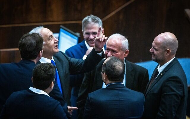 Likud leader MK Benjamin Netanyahu with fellow Likud MKs in the Knesset, on December 28, 2022. (Olivier Fitoussi/Flash90)