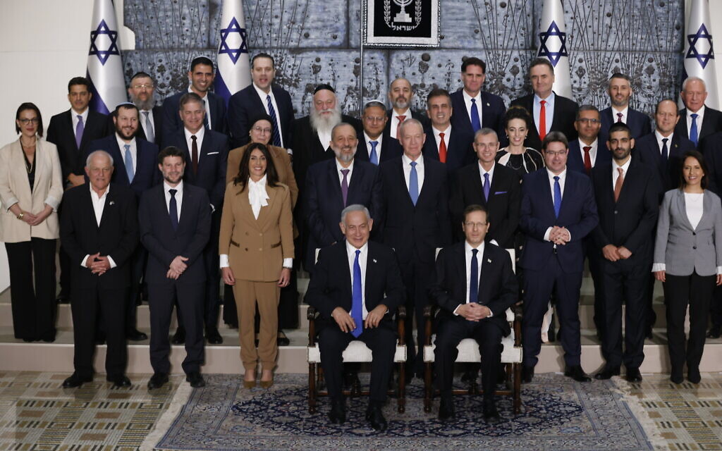 Members of the new Israeli government, headed by Prime Minister Benjamin Netanyahu, pose for a group photo at the president's residence in Jerusalem, on December 29, 2022. (Yonatan Sindel/Flash90)