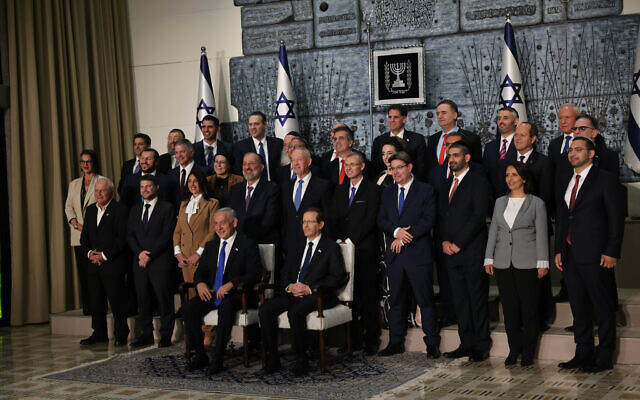 Members of the new Israeli government, headed by Prime Minister Benjamin Netanyahu, pose for a group photo at the President's Residence in Jerusalem, on December 29, 2022. (Yonatan Sindel/Flash90)