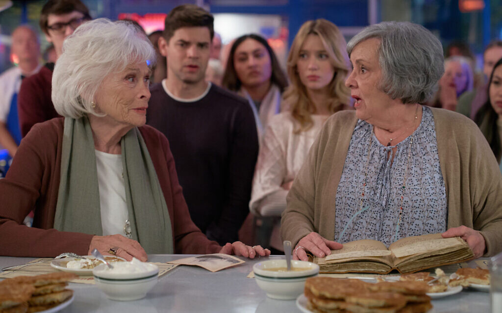 The two grandmothers in 'Hanukkah on Rye' compete in a latke making competition in a scene from the Hallmark movie. (Steven Ackerman/Hallmark Media)