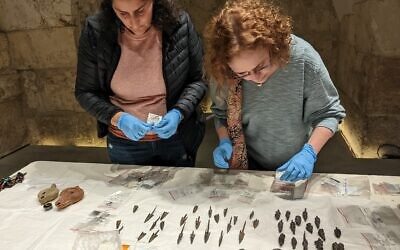 Jessica Lewinsky (left), a conservator, and Ravit Ninner-Soriano, a curator with the Tower of David, pack up the arrowheads to get ready for installation into their permanent display case on December 13, 2022 in Jerusalem. (Melanie Lidman/Times of Israel)