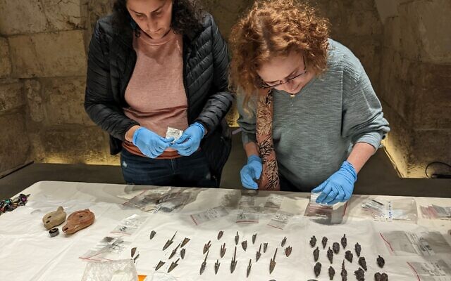 Jessica Lewinsky (left), a conservator, and Ravit Ninner-Soriano, a curator with the Tower of David, pack up the arrowheads to get ready for installation into their permanent display case on December 13, 2022 in Jerusalem. (Melanie Lidman/Times of Israel)