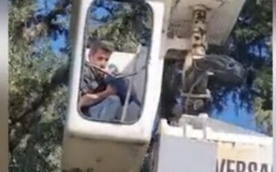 Screen capture from video of Kiryat Shmona Mayor Avi Stern rescuing his parrot, Arthur, with a crane, December 17, 2022. (Walla. Used in accordance with Clause 27a of the Copyright Law)