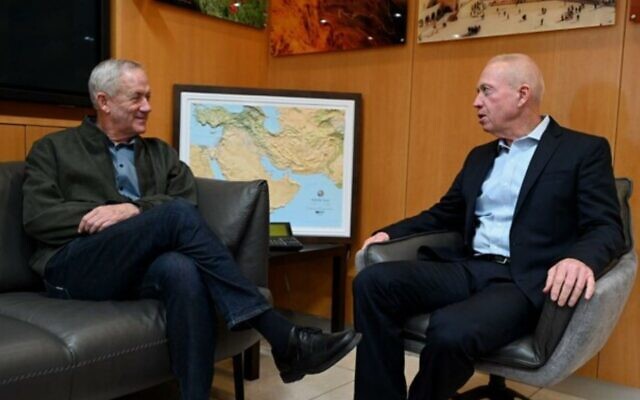 Outgoing defense minister Benny Gantz (L) meets with his successor Yoav Gallant at the Defense Ministry offices in Tel Aviv, December 30, 2022 (Ariel Hermony/Defense Ministry)