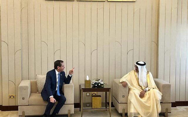 President Isaac Herzog speaks with Bahrain's Foreign Minister  Abdul Latef Al Zayani in Manama, December 4, 2022 (Lazar Berman/The Times of Israel)