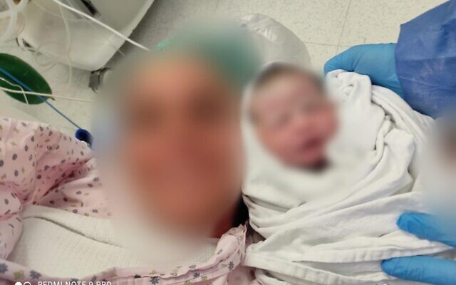 A photo of the mother, who was rushed to Shaare Zedek Medical Center.after a stroke, with her healthy baby girl. The photo has been blurred at the woman's request. (courtesy of Shaare Zedek Medical Center)