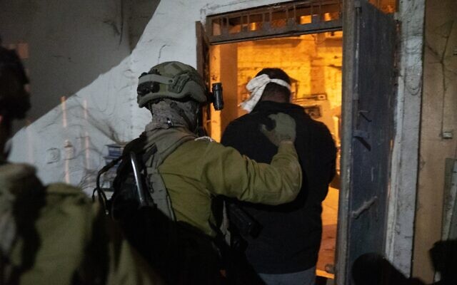 Israeli troops arrest a wanted Palestinian in the West Bank, early December 8, 2022. (Israel Defense Forces)