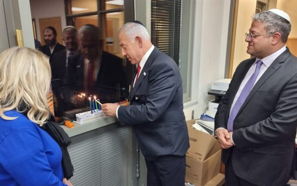 Incoming Prime Minister Benjamin Netanyahu lights Hanukkah candles with his wife Sara and incoming national security minister Itamar Ben Gvir, December 21, 2022 (Youtube screenshot)