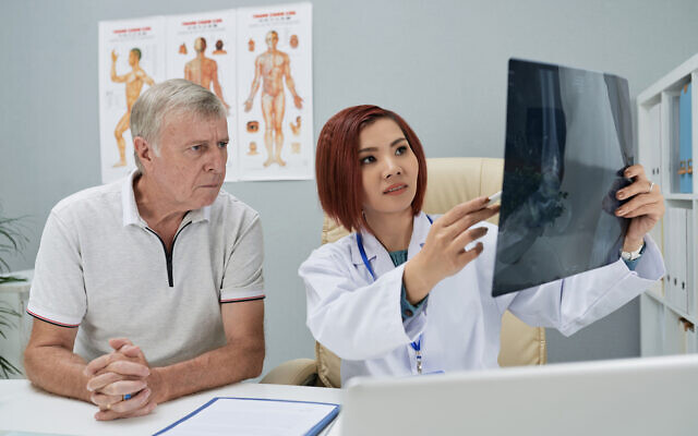Illustrative image: A doctor showing an x-ray of a fracture to a patient (DragonImages via iStock by Getty Images)