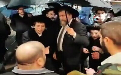 A group of ultra-Orthodox protesters attempt to enter a cultural hall in Jerusalem where ultra-Orthodox are holding a Hanukkah candle-lighting event, December 25, 2022. (Screenshot: Twitter)