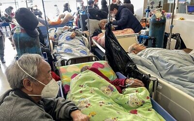 Patients on stretchers are seen at Tongren hospital in Shanghai on January 3, 2023 (Hector RETAMAL / AFP)