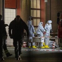 Agents wearing protective suits examine substances on the premises of the fire brigade in Castrop-Rauxel, western Germany, following arrests on suspicion of preparing an 'Islamist attack' using cyanide and ricin,  on January 8, 2023. (Christoph Reichwein / DPA / AFP)