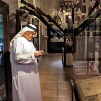 Ahmed al-Mansoori, director of the Crossroads of Civilizations Museum, shows visitors around the Holocaust Gallery, in Dubai on January 11, 2023. (Karim SAHIB / AFP)