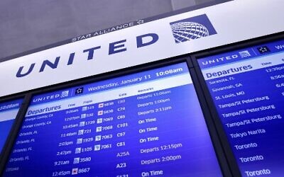 A flight information board lists United Airlines flights, after a nationwide FAA computer outage temporarily grounded air travel, at Newark International Airport, in Newark, New Jersey, on January 11, 2023. (Kena Betancur/AFP)