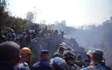 Rescuers gather at the site of a plane crash in the resort town of Pokhara, Nepal, January 15, 2023. (Yunish Gurung/AFP)