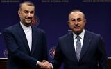 Turkey's Foreign Minister Mevlut Cavusoglu (R) and his Iranian counterpart Hossein Amir-Abdollahian shake hands at the end of their joint press conference in Ankara on January 17, 2023. (Adem Altan/AFP)