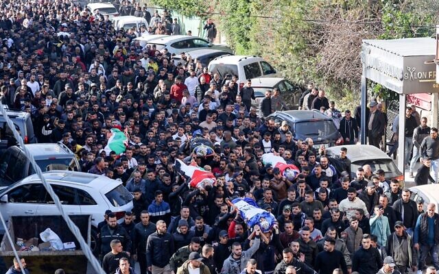 Palestinians carry the bodies of four of the 9 reported victims killed during an Israeli raid on the West Bank's Jenin refugee camp, during their funeral procession in the city of the same name, January 26, 2023. (Jaafar Ashtiyeh/AFP)