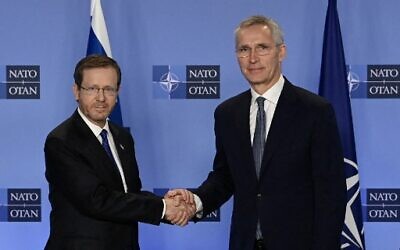 NATO Secretary General Jens Stoltenberg (R) shakes hands with President Isaac Herzog prior to their meeting at the NATO Headquarters in Brussels on January 26, 2023. (Photo by John Thys/AFP)