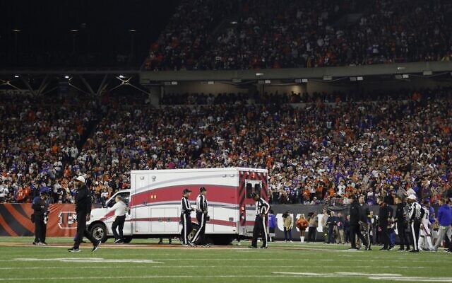 Fans look on as the ambulance leaves carrying Damar Hamlin of the Buffalo Bills, who collapsed after making a tackle against the Cincinnati Bengals during the first quarter at Paycor Stadium on January 02, 2023, in Cincinnati, Ohio (Kirk Irwin / GETTY IMAGES NORTH AMERICA / Getty Images via AFP)