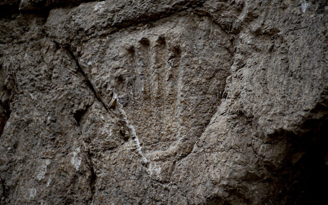 A carved hand imprint discovered in an ancient moat wall around the Old City of Jerusalem. (Yoli Schwartz/Israel Antiquities Authority)