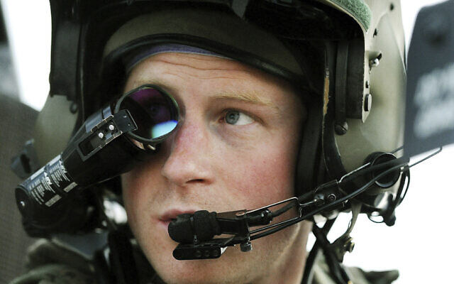 In this file photo from December 12, 2012, Britain's Prince Harry wears his monocle gun sight as he sits in the front seat of his cockpit at the British controlled flight-line in Camp Bastion southern Afghanistan. (AP Photo/John Stillwell, File)