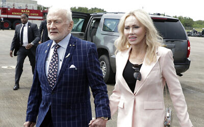 Apollo 11 astronaut Buzz Aldrin, left, and Anca Faur arrive at the Kennedy Space Center for a visit in recognition of the Apollo 11 moon landing anniversary, Saturday, July 20, 2019, in Cape Canaveral, Fla. (AP Photo/John Raoux)