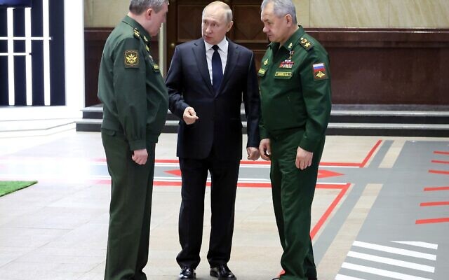 Russian President Vladimir Putin, center, speaks with Chief of the General Staff Gen. Valery Gerasimov, left, and Russian Defense Minister Sergei Shoigu, after a meeting with senior military officers in Moscow, Russia, Wednesday, Dec. 21, 2022. (Mikhail Klimentyev, Sputnik, Kremlin Pool Photo via AP)