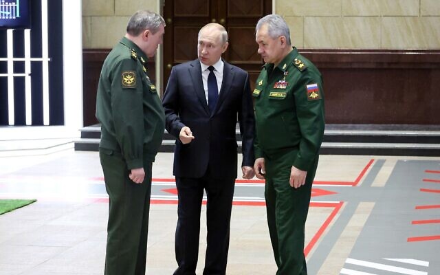 Russian President Vladimir Putin, center, speaks with Chief of the General Staff Gen. Valery Gerasimov, left, and Russian Defense Minister Sergei Shoigu, after a meeting with senior military officers in Moscow, Russia, December 21, 2022. (Mikhail Klimentyev, Sputnik, Kremlin Pool Photo via AP)