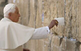 FILE - In this May 12, 2009 file photo, Pope Benedict XVI places a note in the Western Wall, Judaism's holiest site, in Jerusalem's Old City. (AP Photo/David Silverman, Pool)
