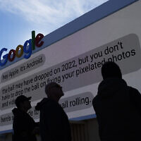 Workers help set up the Google booth at the Las Vegas Convention Center before the start of the CES tech show, January 2, 2023, in Las Vegas. (AP/John Locher)
