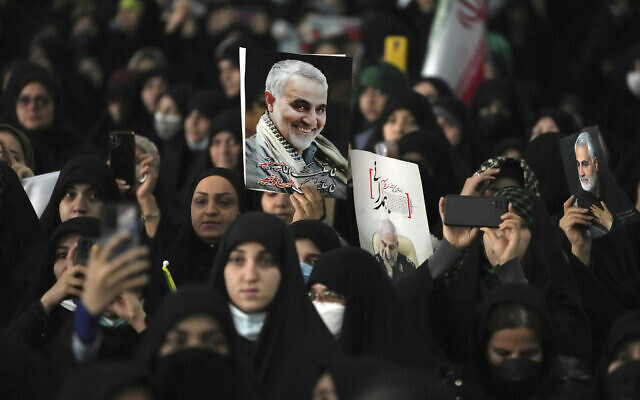 Mourners attend a ceremony marking anniversary of the death of the late Revolutionary Guard Gen. Qassem Soleimani, shown in the posters, who was killed in Iraq in a US drone attack in 2020, at Imam Khomeini Grand Mosque in Tehran, Iran, January 3, 2023. (Vahid Salemi/AP)
