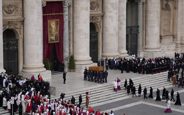 The coffin of late Pope Emeritus Benedict XVI is carried away after a funeral mass in St. Peter's Square at the Vatican, Thursday, Jan. 5, 2023. Benedict died at 95 on Dec. 31 in the monastery on the Vatican grounds where he had spent nearly all of his decade in retirement. (AP Photo/Ben Curtis)
