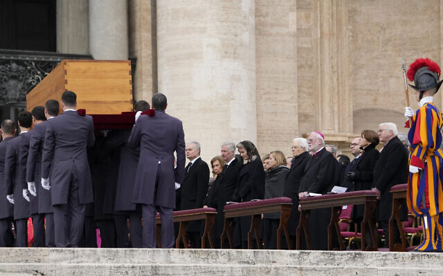 Dignitaries watch as the coffin of late Pope Emeritus Benedict XVI is carried away after a funeral mass in St. Peter's Square at the Vatican, Thursday, Jan. 5, 2023. Benedict died at 95 on Dec. 31 in the monastery on the Vatican grounds where he had spent nearly all of his decade in retirement. (AP Photo/Andrew Medichini)