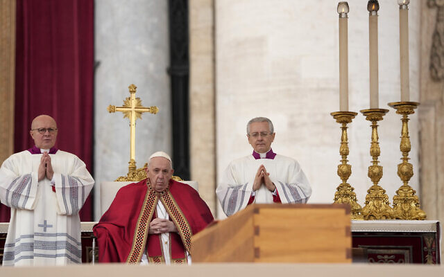 Pope Francis sits by the coffin of late Pope Emeritus Benedict XVI in St. Peter's Square during a funeral mass at the Vatican, Thursday, Jan. 5, 2023. Benedict died at 95 on Dec. 31 in the monastery on the Vatican grounds where he had spent nearly all of his decade in retirement. (AP Photo/Andrew Medichini)