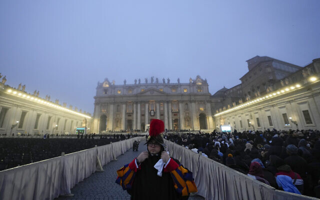 A guard stands as the fog covers the St. Peter's Basilica Dome in St. Peter's Square at the Vatican ahead of the funeral mass for late Pope Emeritus Benedict XVI, Thursday, Jan. 5, 2023. Benedict died at 95 on Dec. 31 in the monastery on the Vatican grounds where he had spent nearly all of his decade in retirement, his days mainly devoted to prayer and reflection. (AP Photo/Alessandra Tarantino)