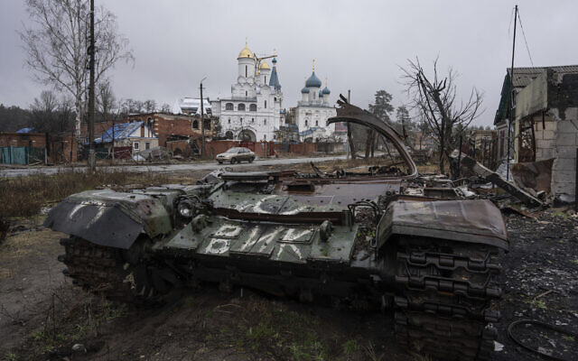 A destroyed Russian tank stands across the road from a church in the town of Sviatohirsk, Ukraine, January 6, 2023. (AP/Evgeniy Maloletka)