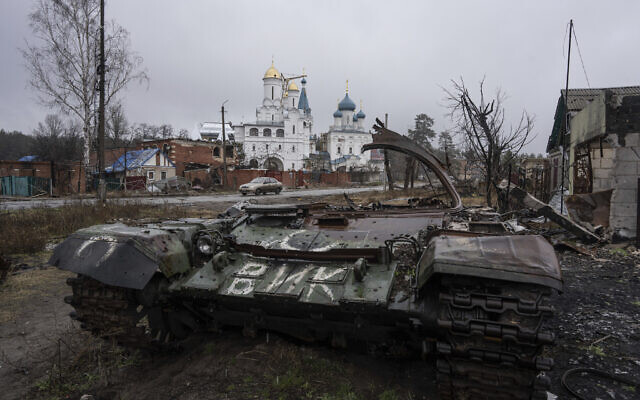 A destroyed Russian tank stands across the road of a church in the town of Sviatohirsk, Ukraine, Friday, January 6, 2023. (AP Photo/Evgeniy Maloletka)