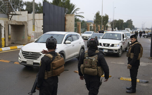 Iraqi security forces stand guard as they check motorists entering the Green Zone, in Baghdad, Iraq, Jan. 8, 2023. (AP Photo/Hadi Mizban)