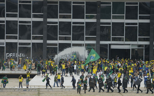 Protesters, supporters of Brazil's former President Jair Bolsonaro, storm the Supreme Court building in Brasilia, Brazil, Sunday, Jan. 8, 2023. (AP/Eraldo Peres)