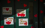 Messages of support for teacher Abby Zwerner, who was shot by a 6 year old student, grace the front door of Richneck Elementary School Newport News, Virginia on Jan. 9, 2023. (AP Photo/John C. Clark)