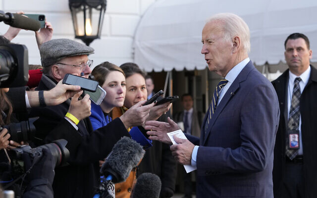 US President Joe Biden talks with reporters before he and first lady Jill Biden board Marine One on the South Lawn of the White House in Washington, Wednesday, Jan. 11, 2023.  (AP Photo/Susan Walsh)