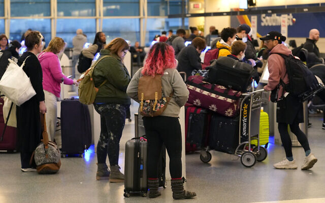 Passengers check in at Southwest Airlines' self serve kiosks at Chicago's Midway Airport as flight delays stemming from a computer outage at the Federal Aviation Administration has brought flights to a standstill across the US Wednesday, Jan. 11, 2023, in Chicago. (AP Photo/Charles Rex Arbogast)