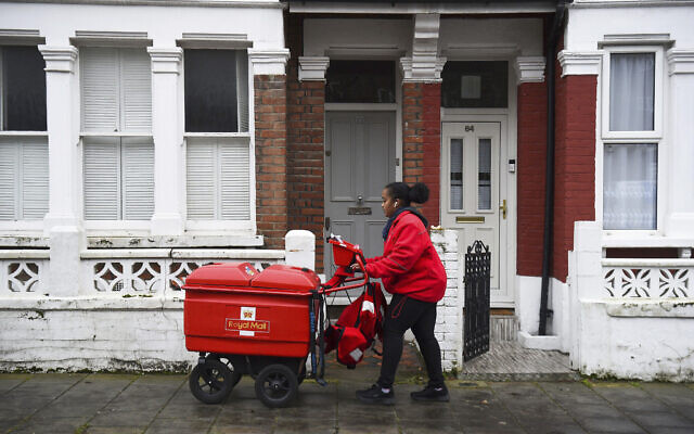 File: Royal Mail postwoman Leila delivers mail in Balham, London, January 12, 2021. (Kirsty O'Connor/PA via AP)