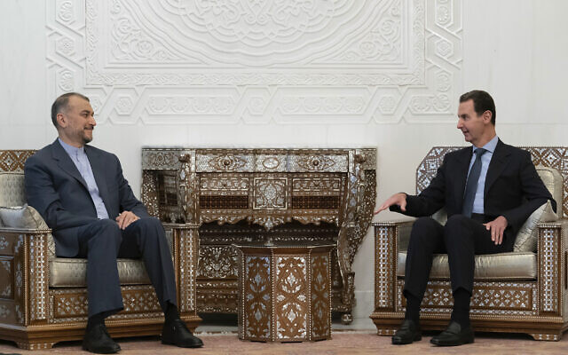 In this photo released on the official Facebook page of the Syrian Presidency, Syrian President Bashar Assad, right, meets with Iranian Foreign Minister Hossein Amir-Abdollahian in Damascus, Syria, January 14, 2023. (Syrian Presidency Facebook page via AP)